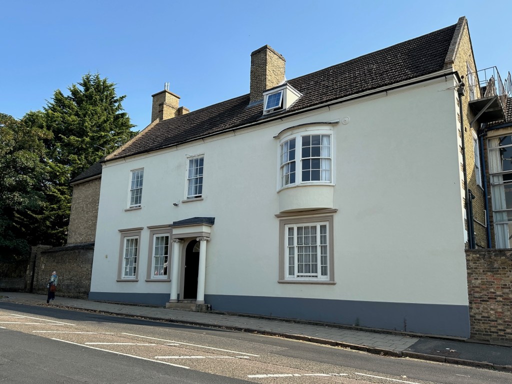 Hill House, Back Hill, Ely. 2024. Whitewashed facade, a slim pillar each side of the front door, the off balanced arrangement of windows suggests it was extended early in its life.
