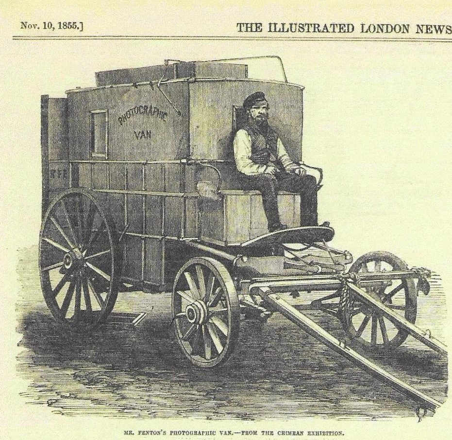 Roger Fenton's photographic wagon, looking like a carriage with all the windows covered. A man is posed on the driving seat but no horses are between the shafts.